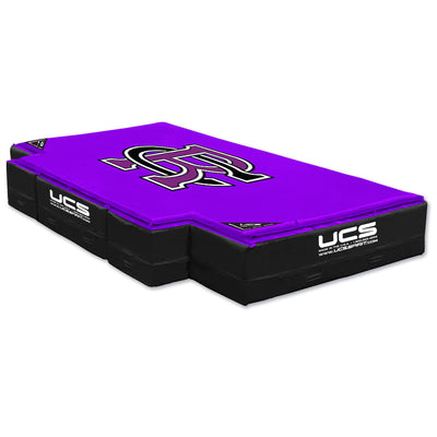 A purple and black UCS High Jump landing area with a large purple logo on top, shown on a plain white background.