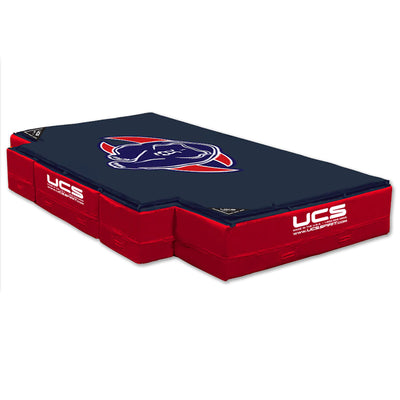 A High Jump Landing Area with navy blue top featuring the UCSB Carabees logo, and red side padding with white UCS branding.