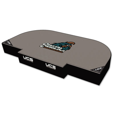 A high jump landing area with a curved top, featuring the Coastal Carolina Gamecocks logo in the center and 'UCS' branding on the black side panels, shown on a white background.