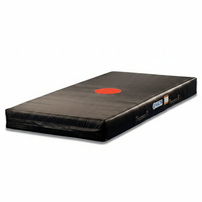 Black Stunt Landing mat with a red circle and UCS branding on a white background