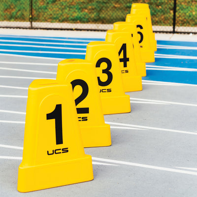 Yellow numbered cones on a track with 'UCS' branding
